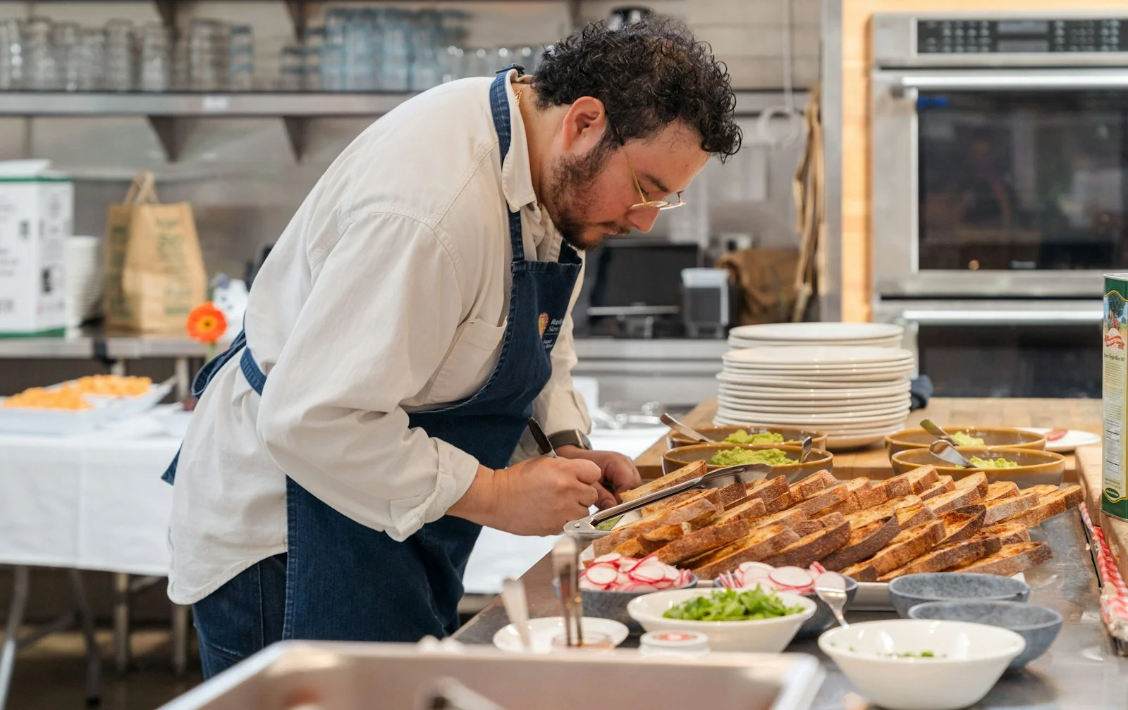 Chef-owner standing in front of a buffet