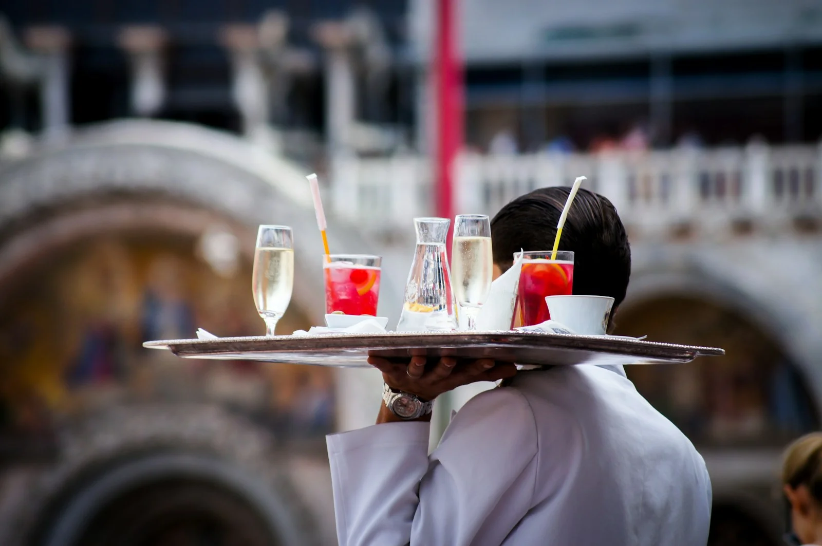 Server carrying a tray of drinks at a reception