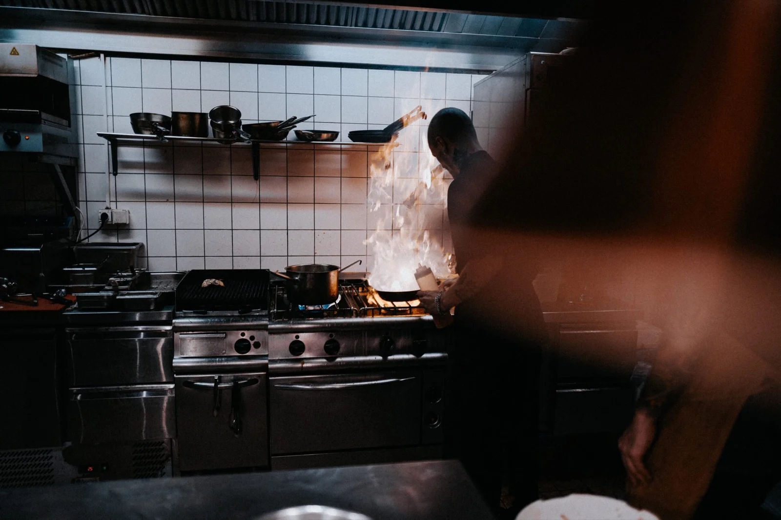 Cook in front of a flare-up in a professional kitchen