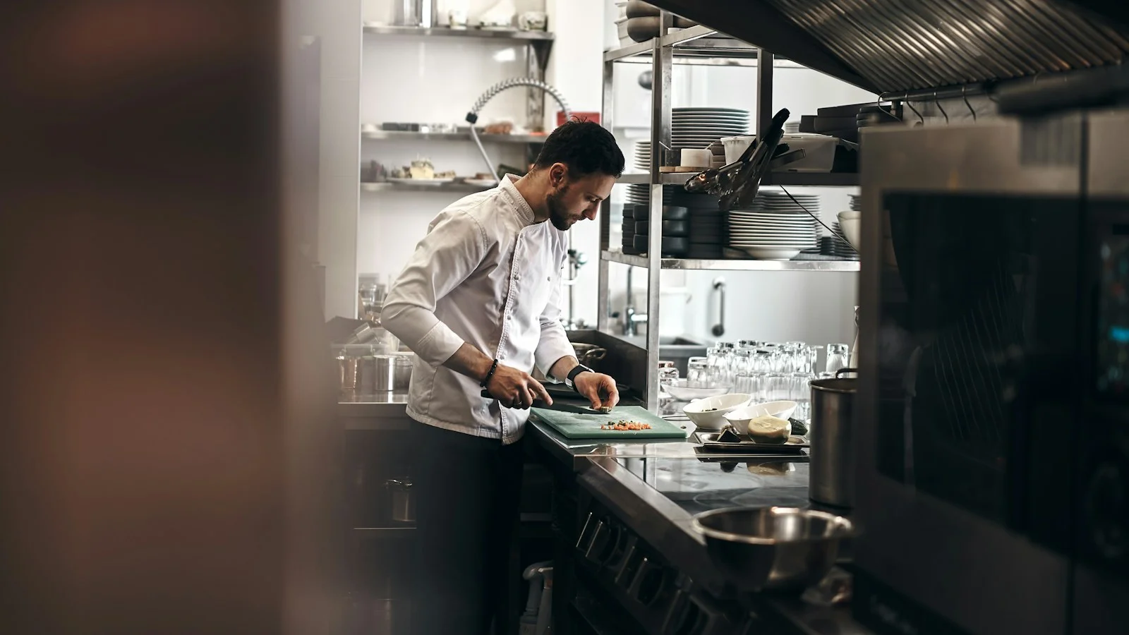 Cook at their station in a professional kitchen